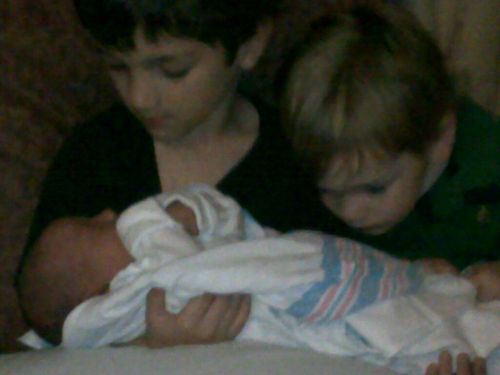 Brothers don't shake hands! Brothers gotta hug... their baby sister. 2nd day, all is well. 